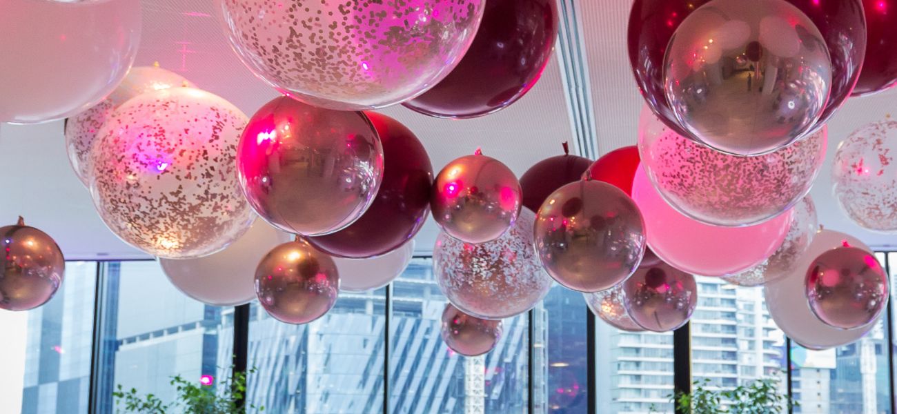 Pink balloons floating on ceiling